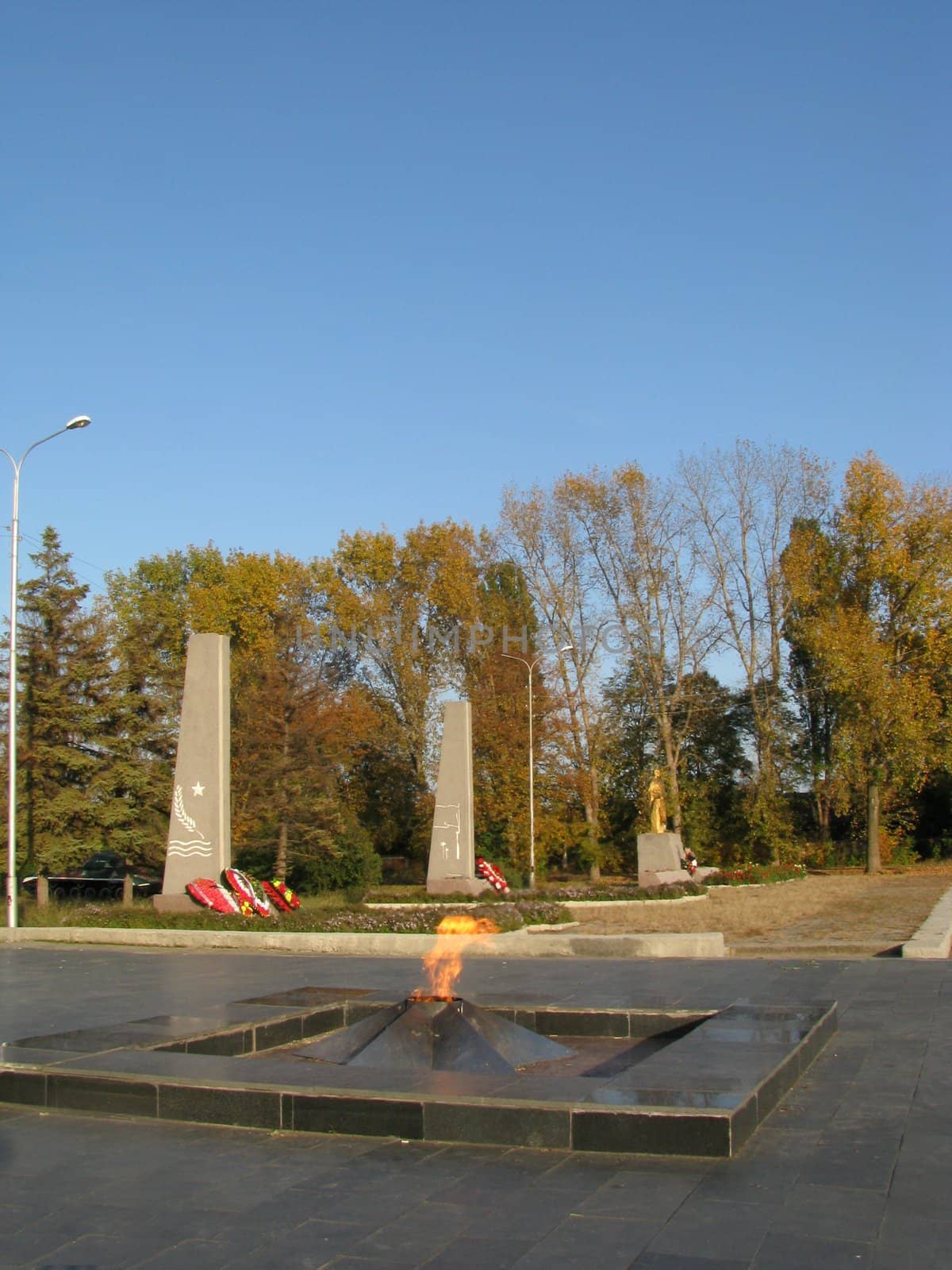 Monument; eternal flame; laid; architectral building; styles; park; garden