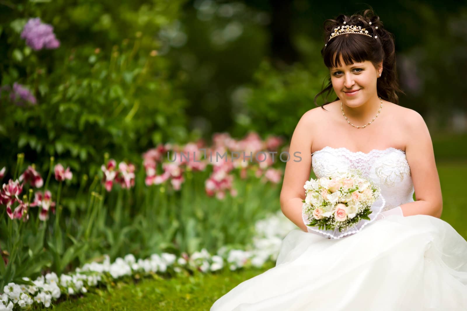 Beautiful brunette Bride in summer park smiling happy