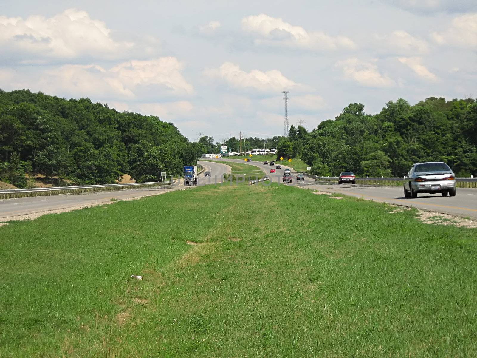 A photograph of automobiles traveling on a road.