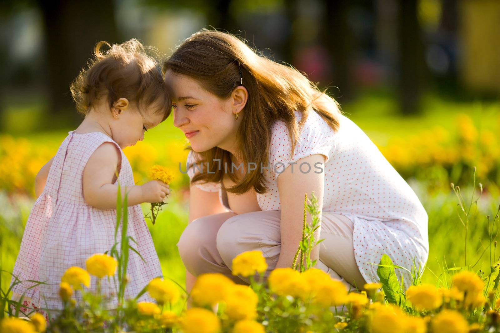 Happy mother walking with daughter in park outdoors