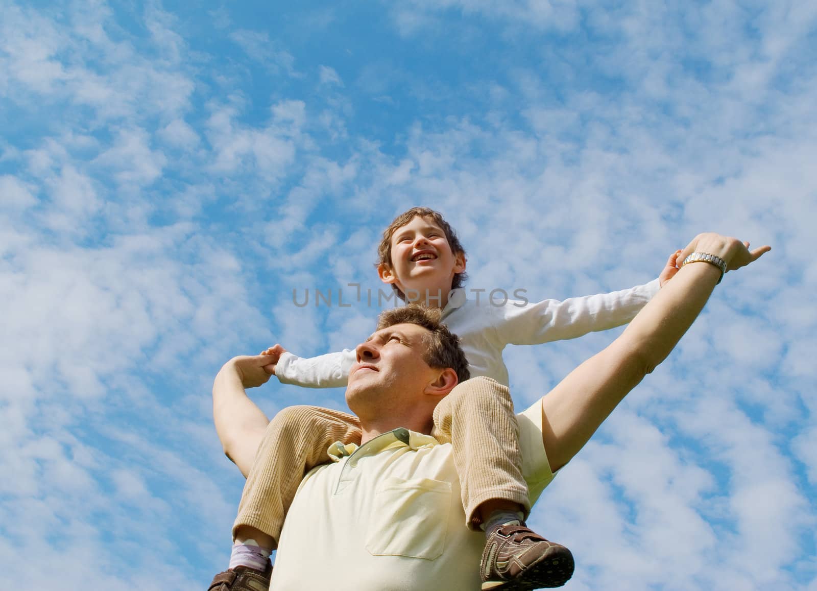The father and his son against the blue sky