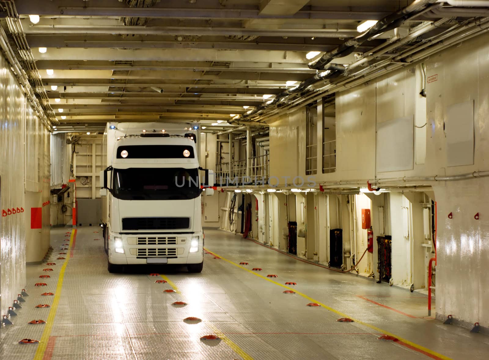 White truck on the cargo deck of the ferry