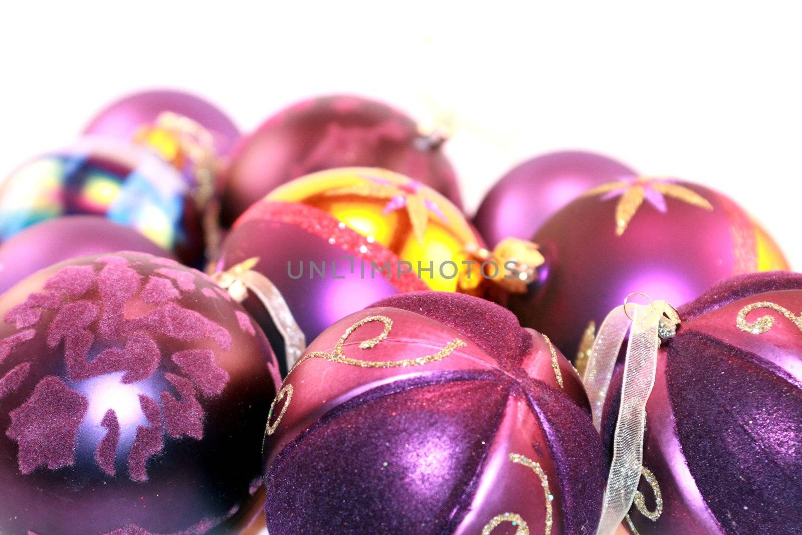 Colorful purple metallic Christmas ornaments for the holidays. Christmas tree decorations for the season.