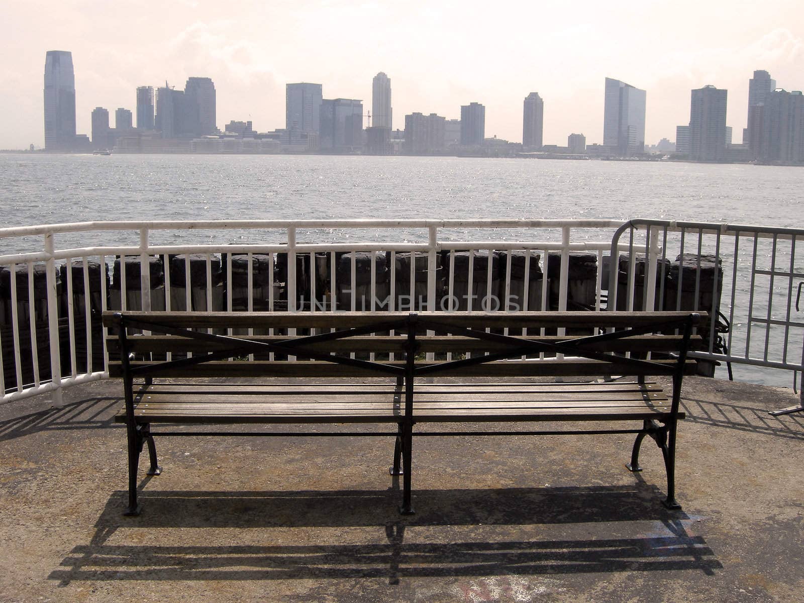 jersey city viewed from Manhattan, wooden bench in foreground