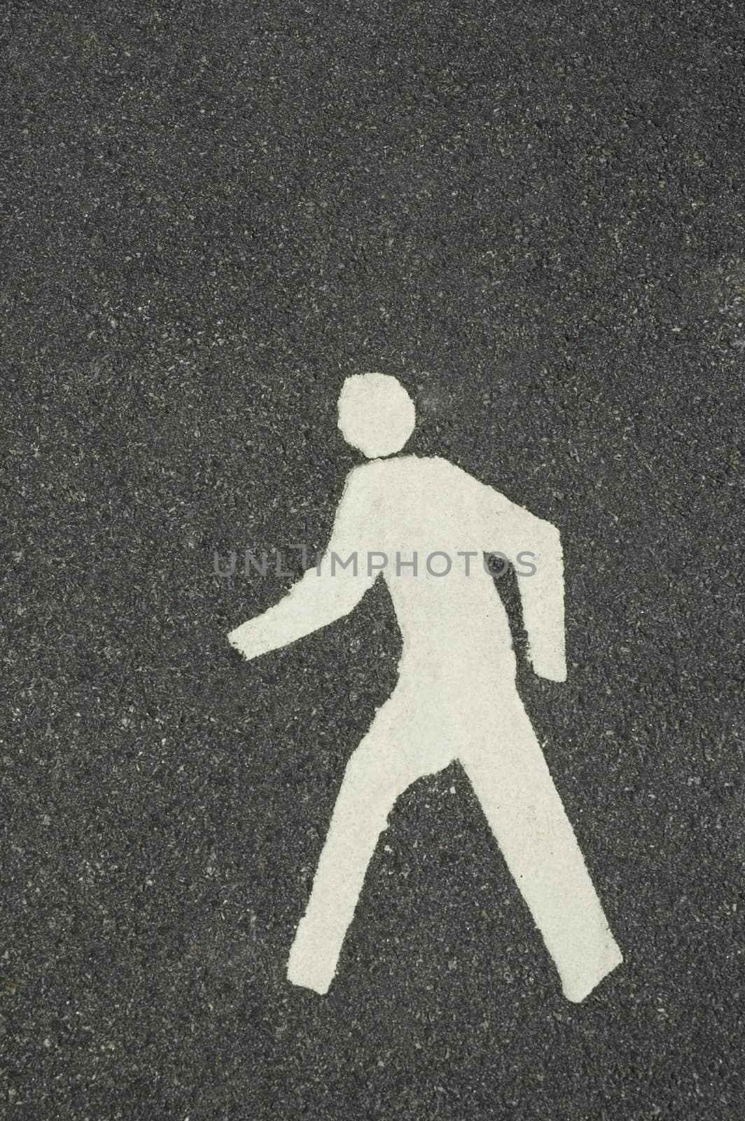 white footpath symbol of walking man, grey asphalt background
