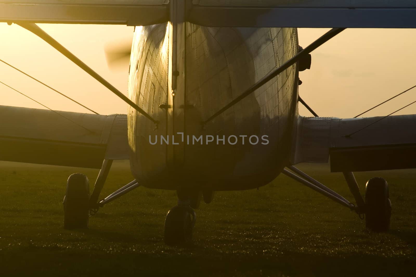 detail photo of an airplane, propeller in motion, big contrast, back light