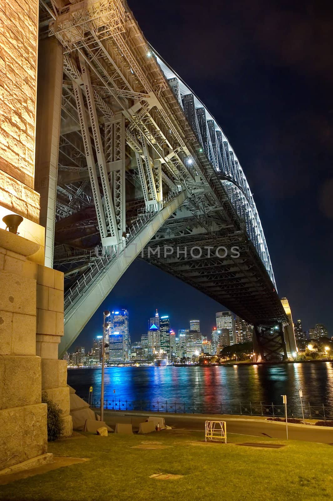 harbour bridge and sydney cbd at night, reflections in water