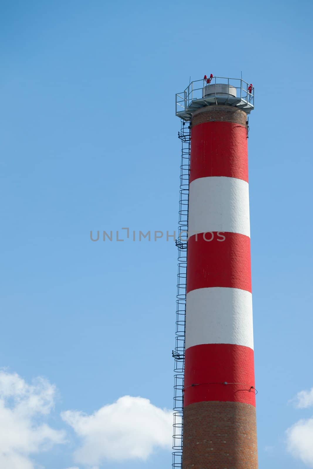 Chimney of an industrial plant against blue sky