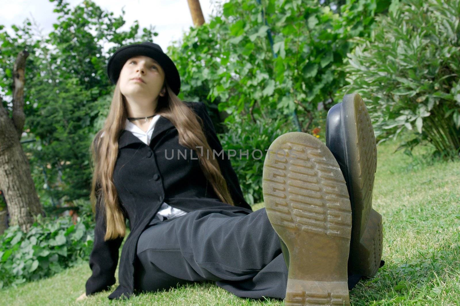Girl sitting in a park, focus on the feet