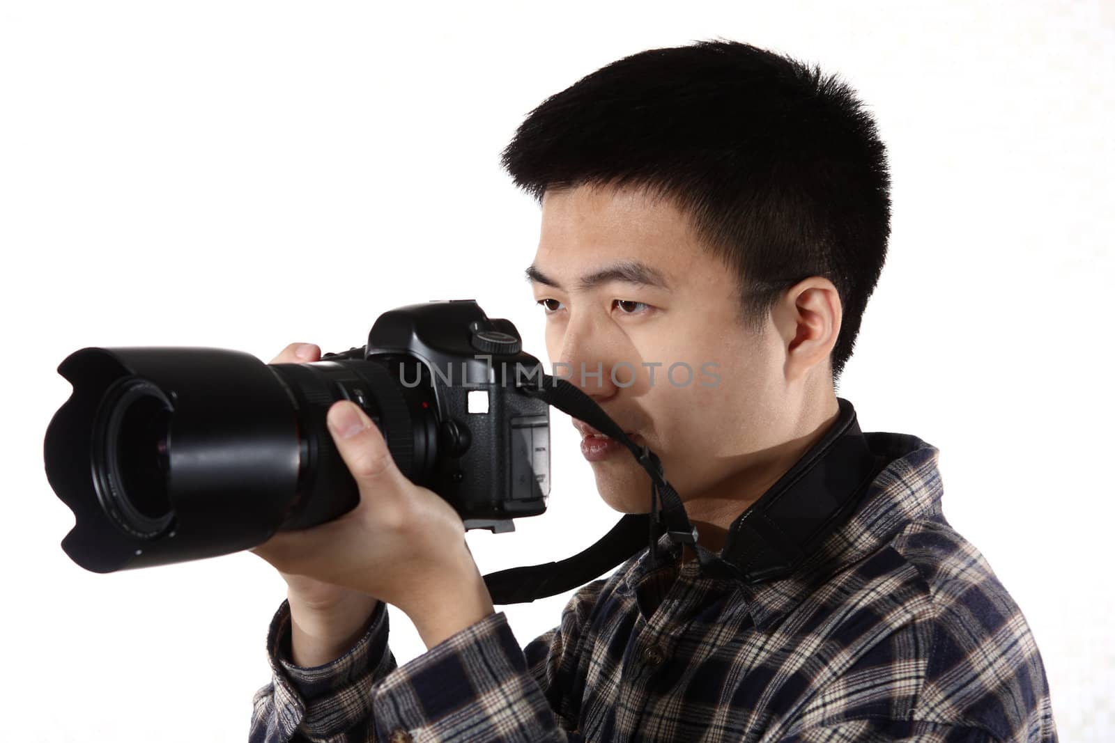 Young chinese male photographer at studio, isolated on white 