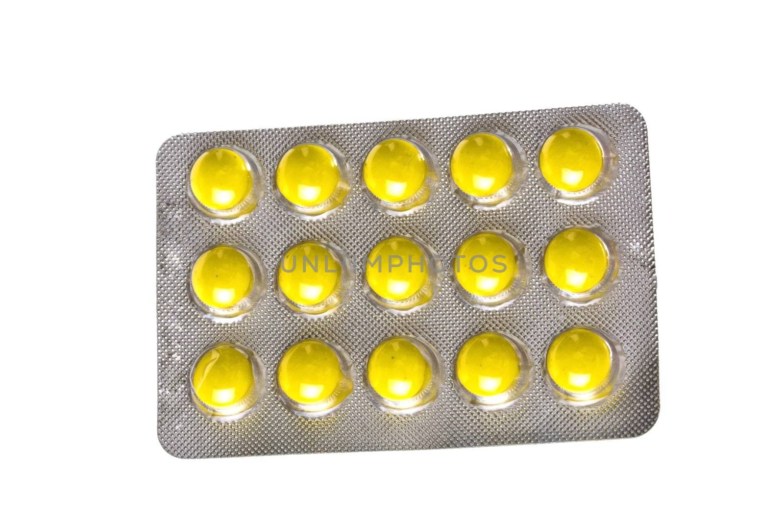 Package of yellow pills isolated on white