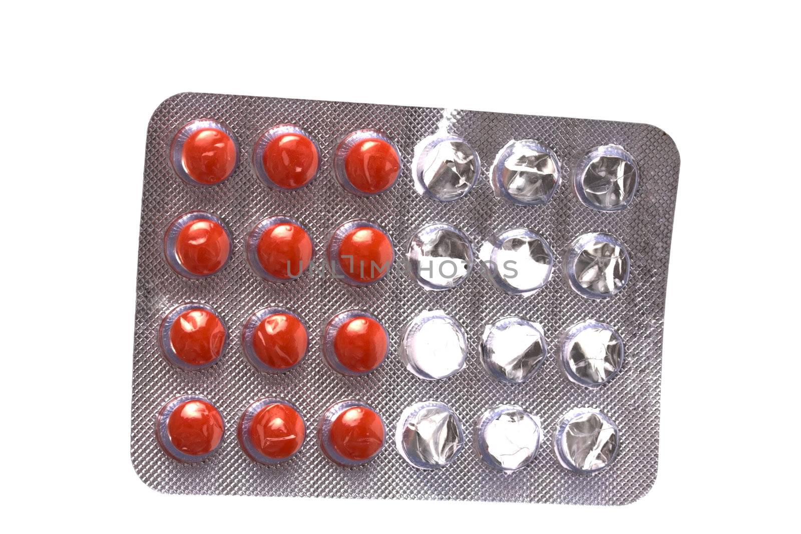 Package of red pills isolated on white