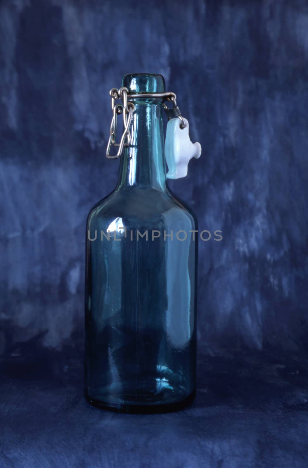 A empty bottle isolated on blue background