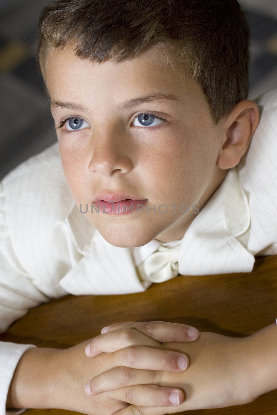 Boy praying during his first holy communion mass