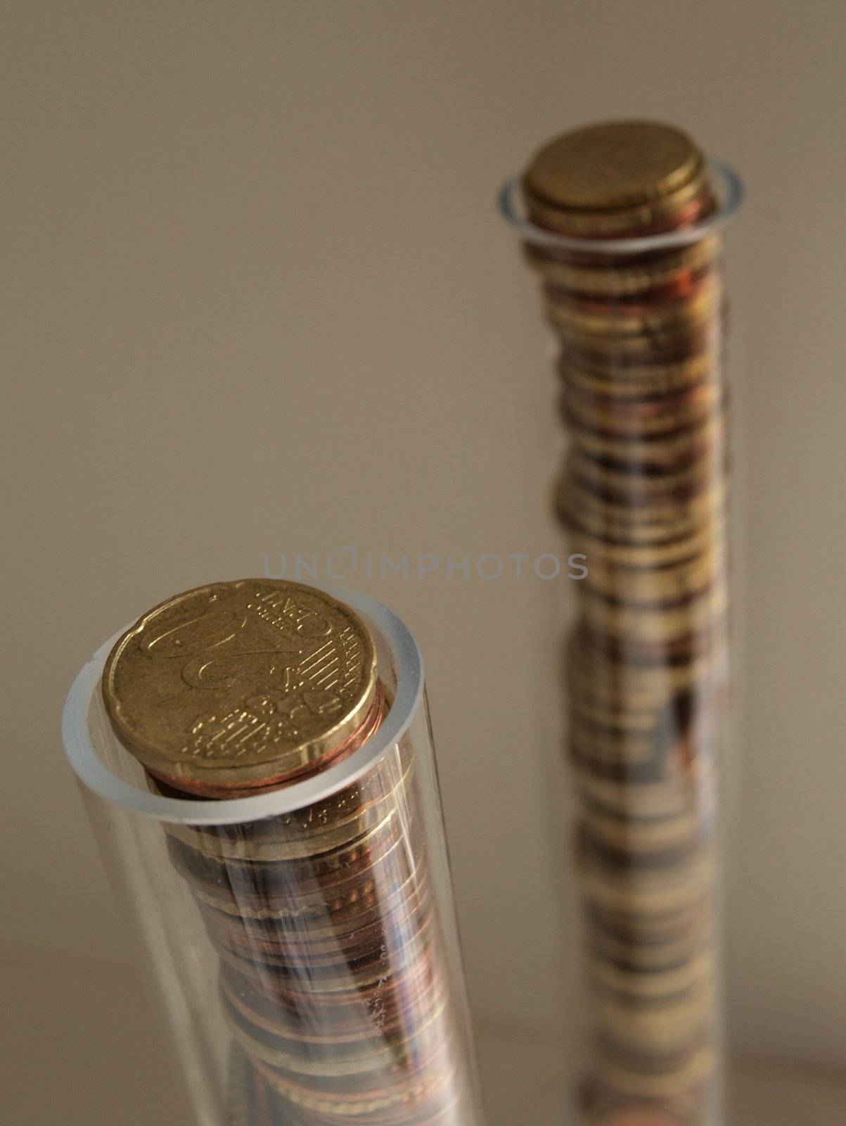 Columns of euro coins in transparent tubes