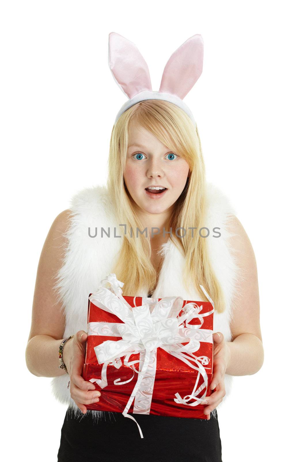 Happy smiling girl with a gift in a rabbit costume isolated on white background