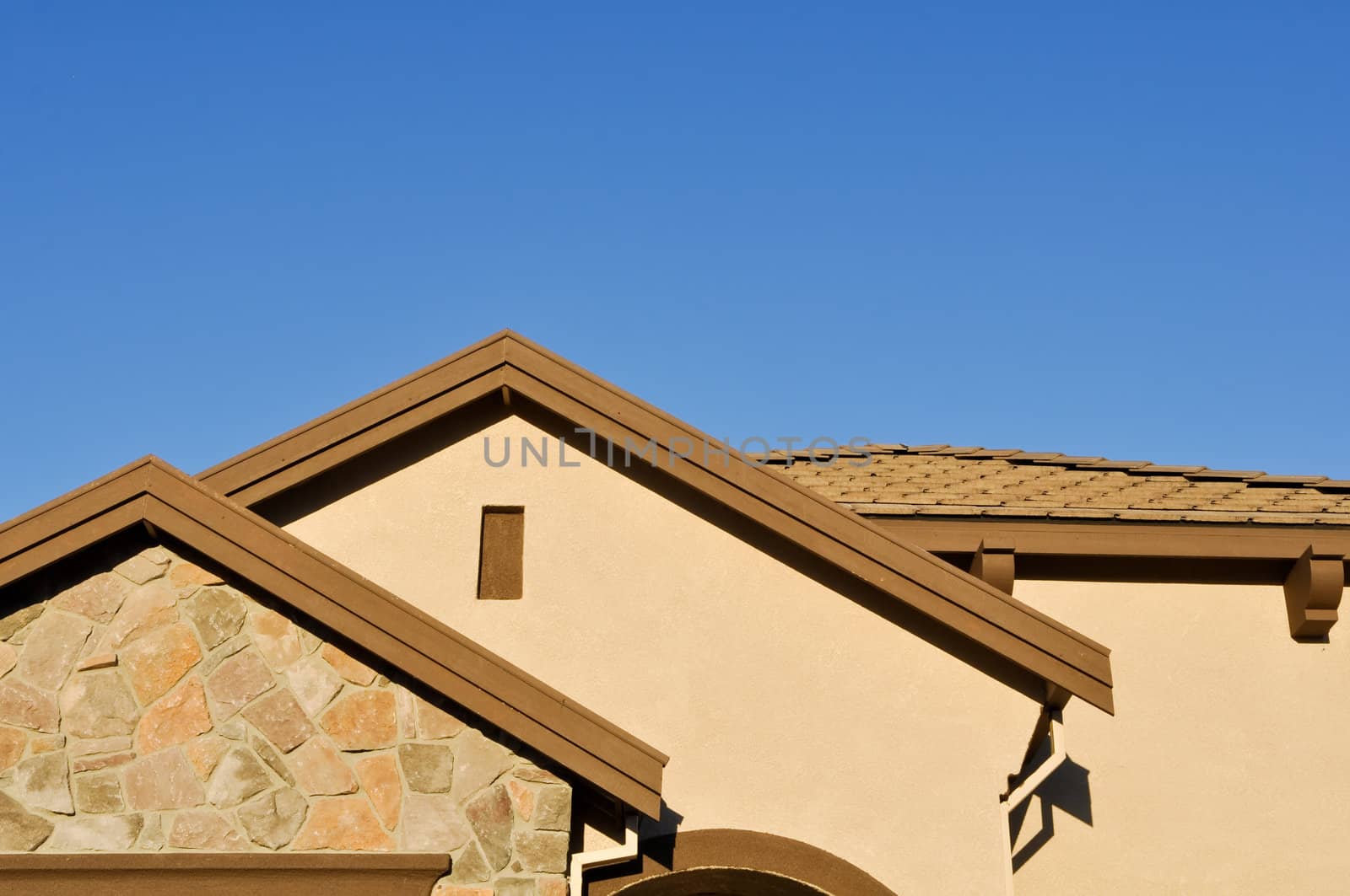 New Stucco Home Under Construction with Blue Sky
