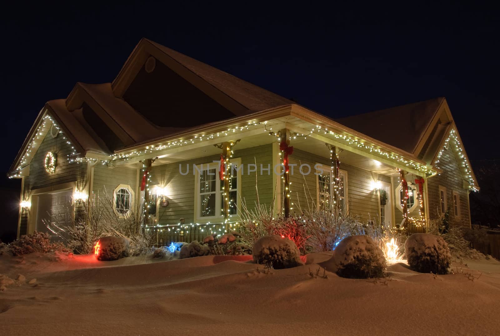 Christmas House decorated with lights at night in Winter