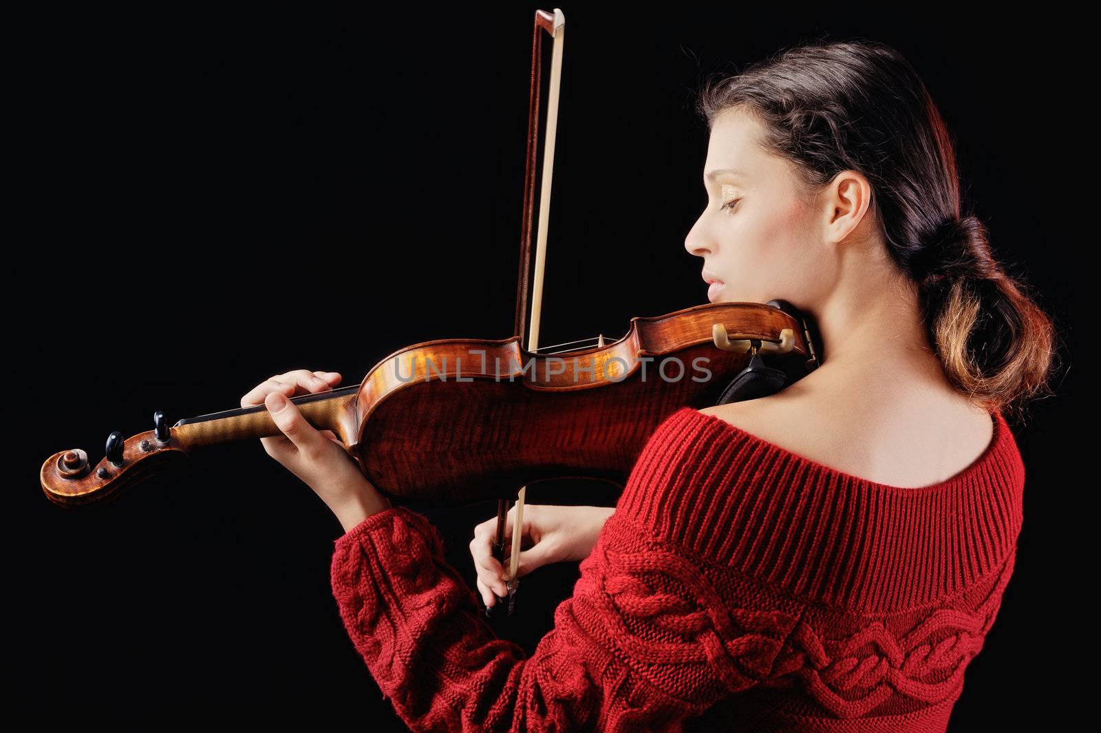 Musician playing violin. Isolated on the black background