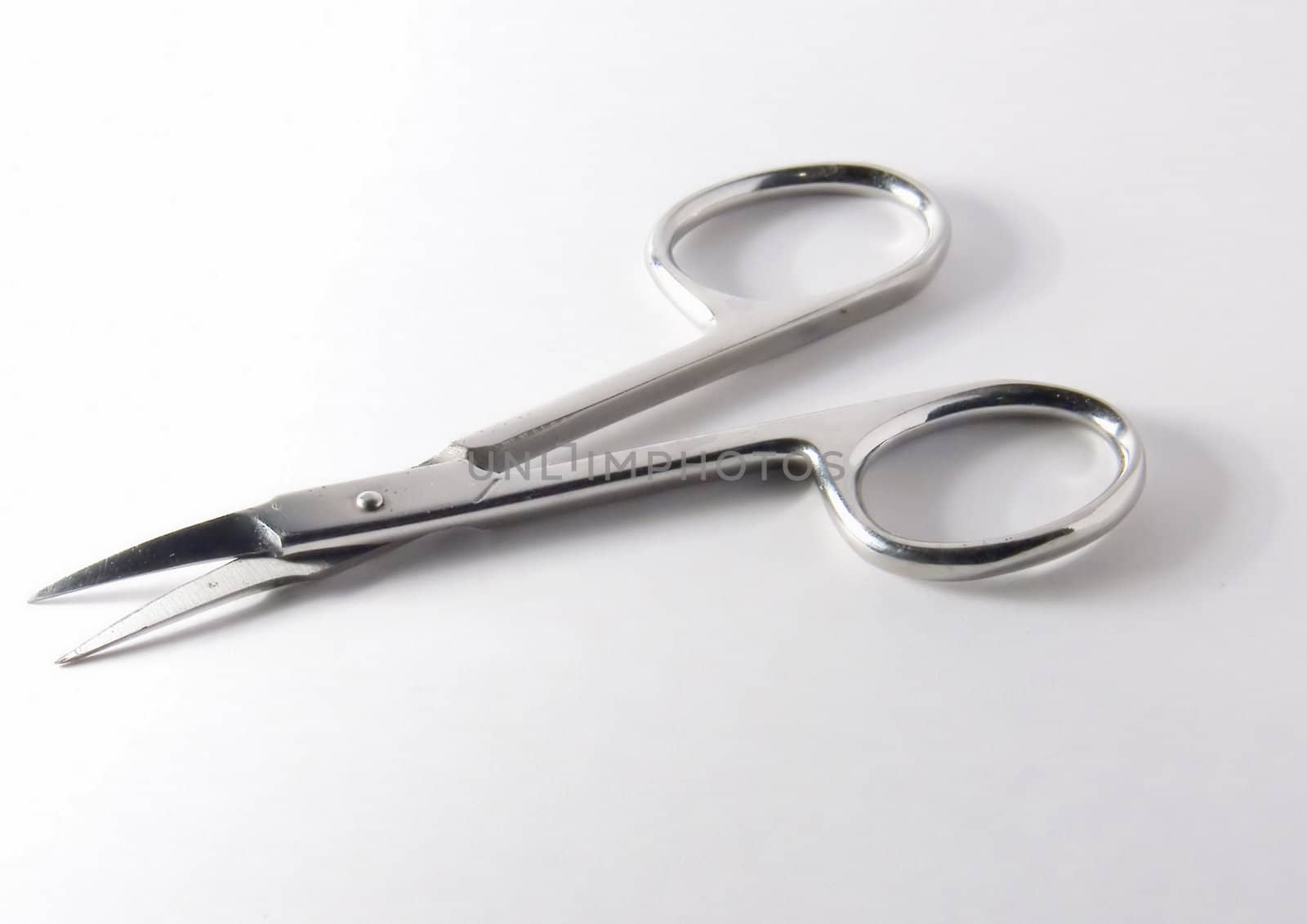 Small metal manicure scissors on a white background