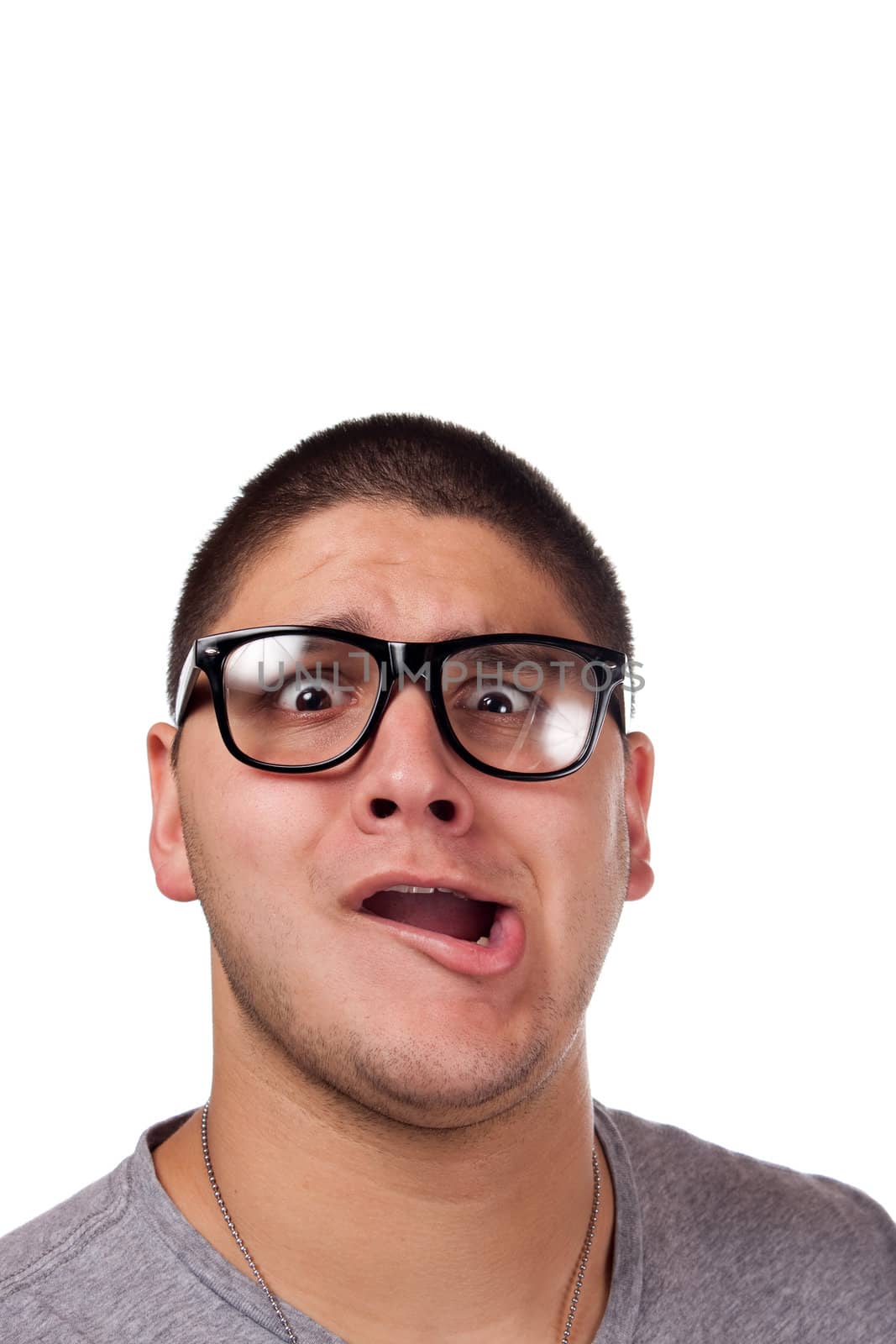 A goofy man wearing trendy nerd glasses isolated over white with a funny expression on his face.