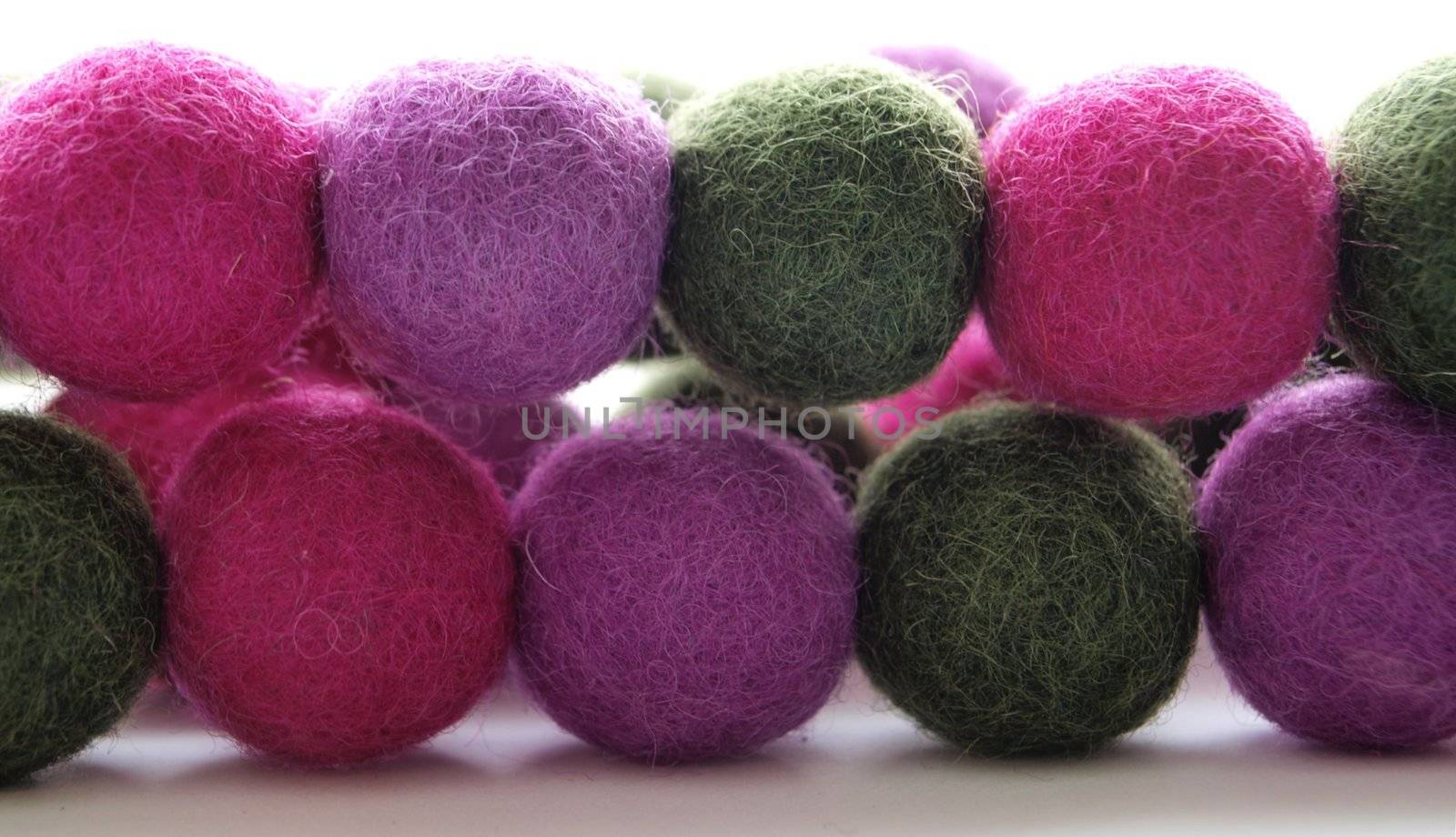 Round hand-made felted wool balls arranged in two lines