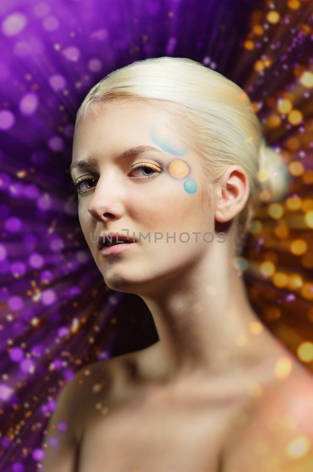 Portrait of a beautiful dreaming woman in coloured lens flares
