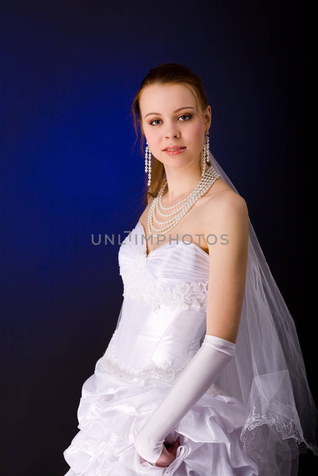 Bride with piercing look over dark blue background
