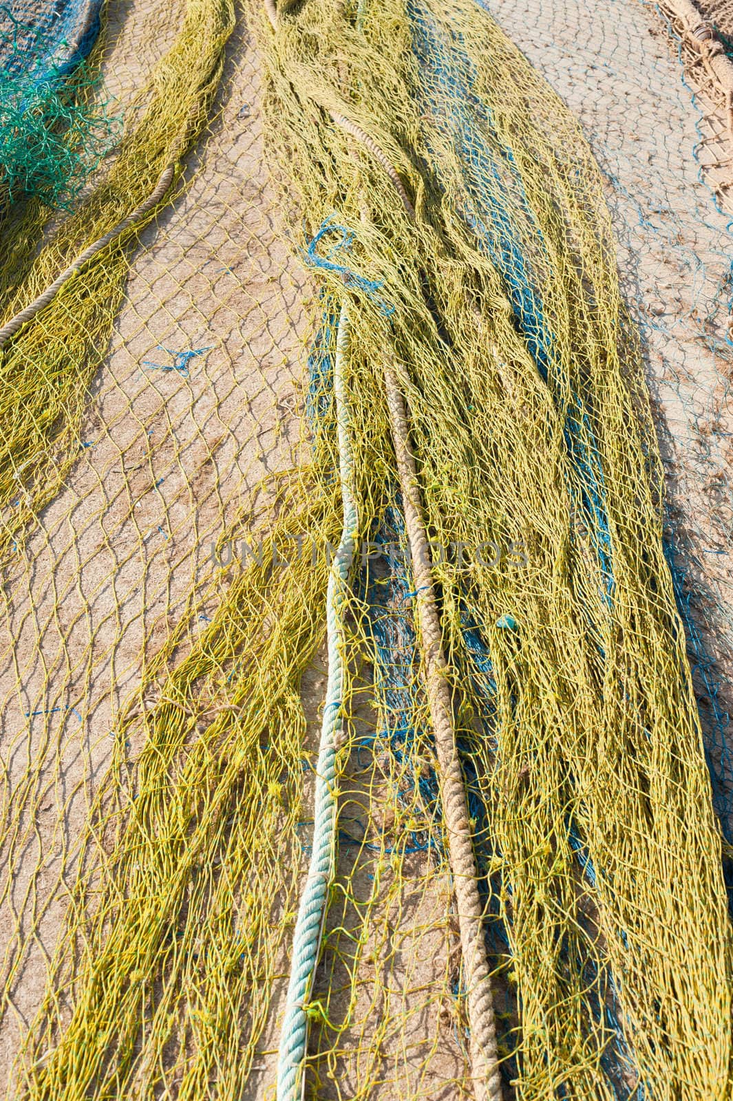 Colorful fishing nets spread on a pier, background