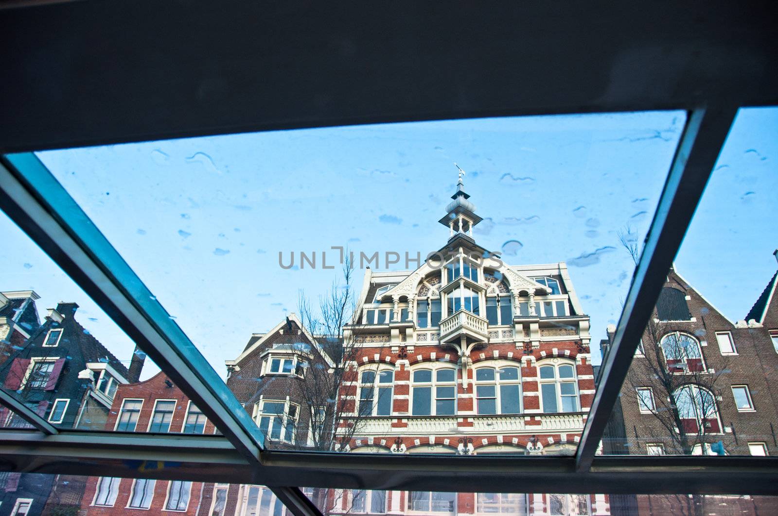 Typical old Amsterdam houses - view through the window of a canal boat