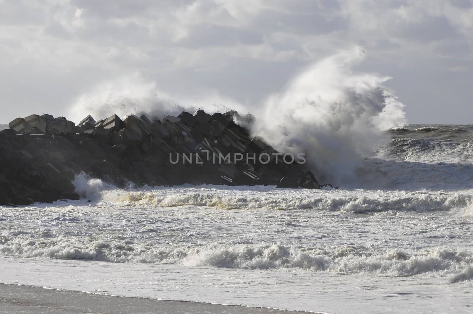 Very big wave on a concrete blocks jetty during a storm