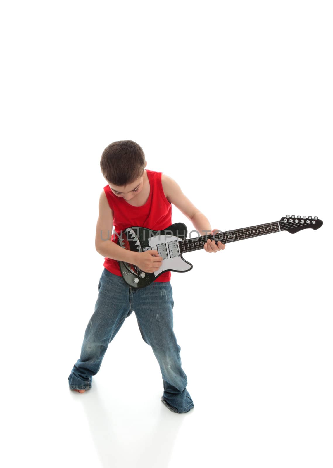 A young boy plays a musical instrument.  White background.