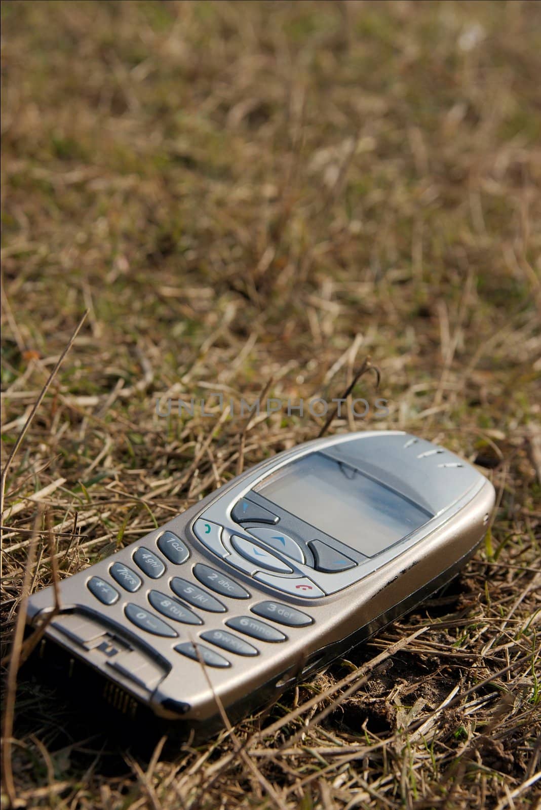 Closeup of a mobile phone in the grass