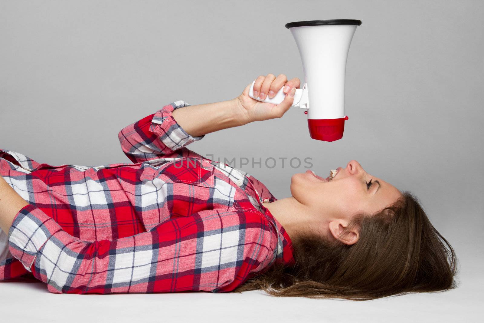 Beautiful young woman holding megaphone