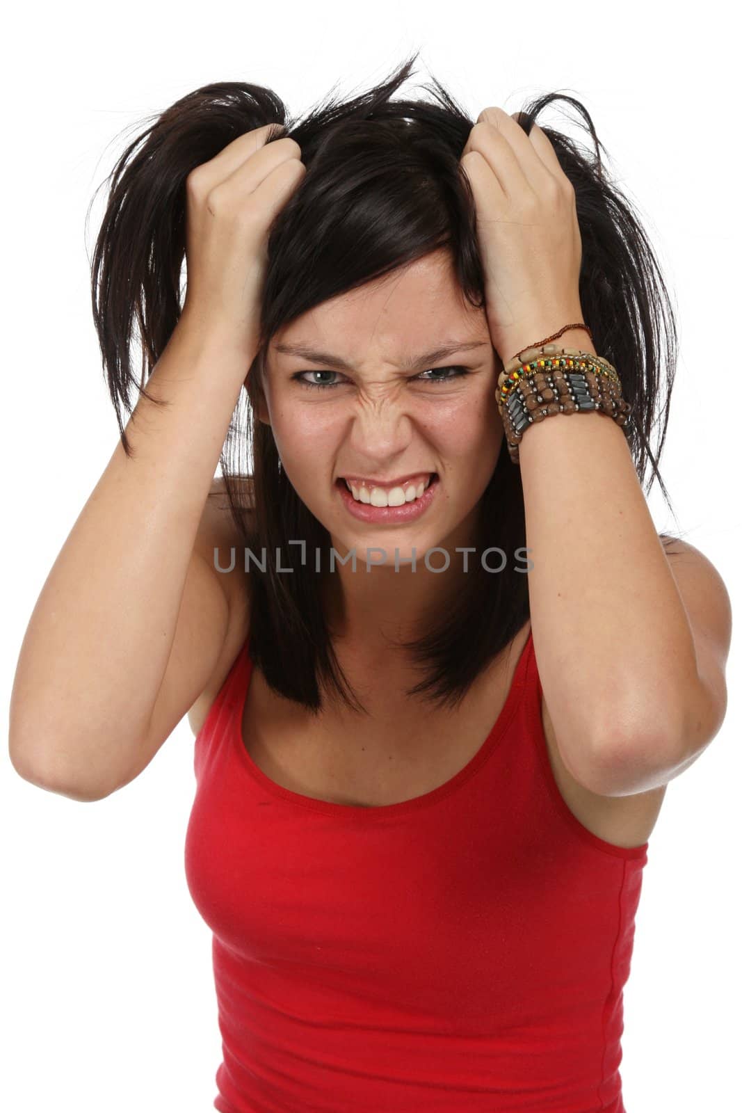 Pretty young lady with frustrated look and hands in her hair