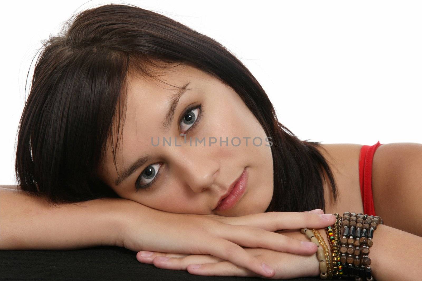 Beautiful young lady with her head resting on her hands