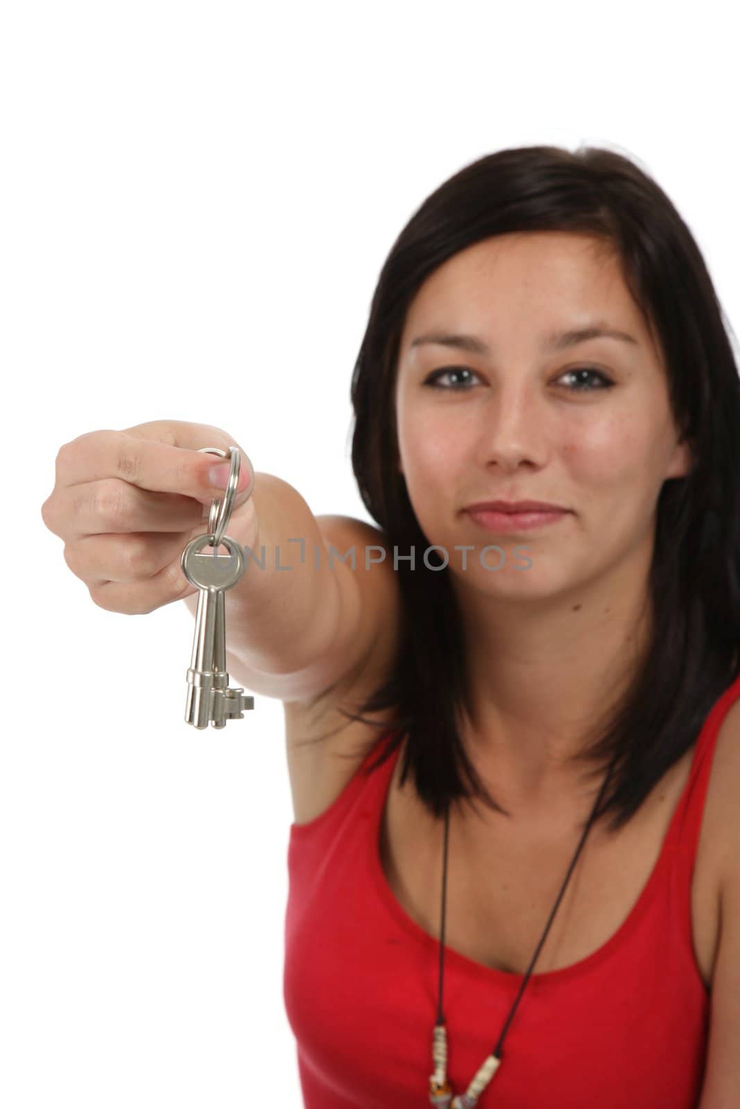 Gorgeous young brunette lady holding keys out in her hand