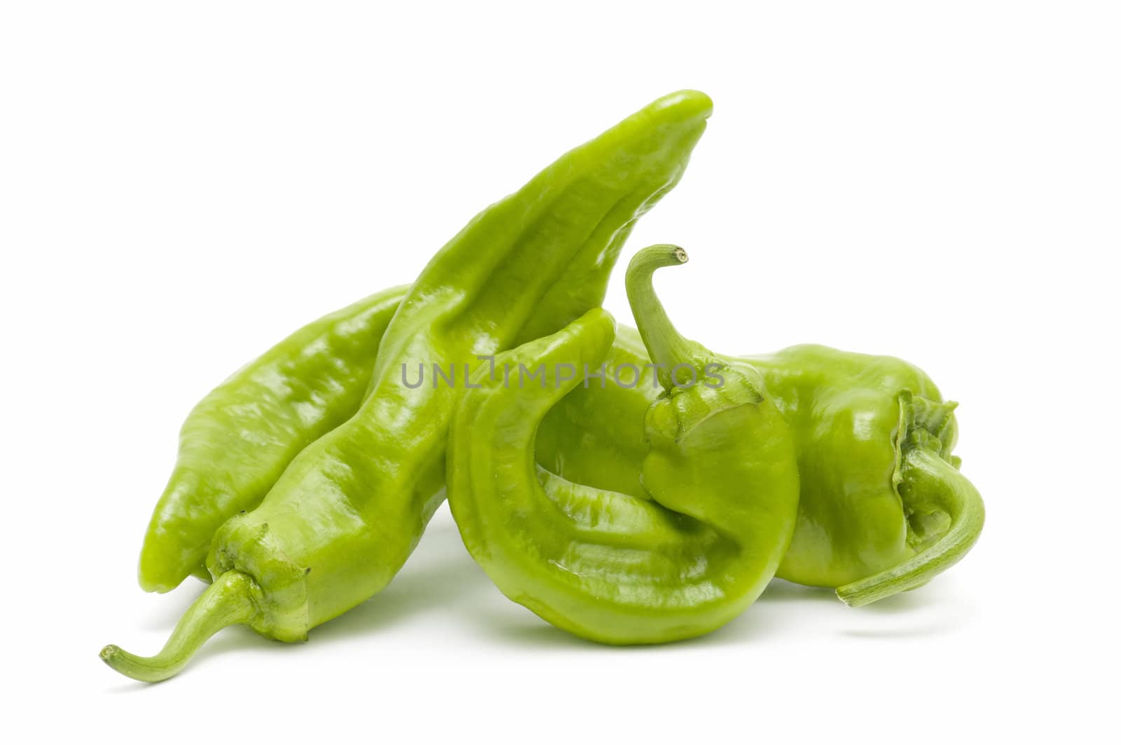 freshly harvested green peppers on a white background
