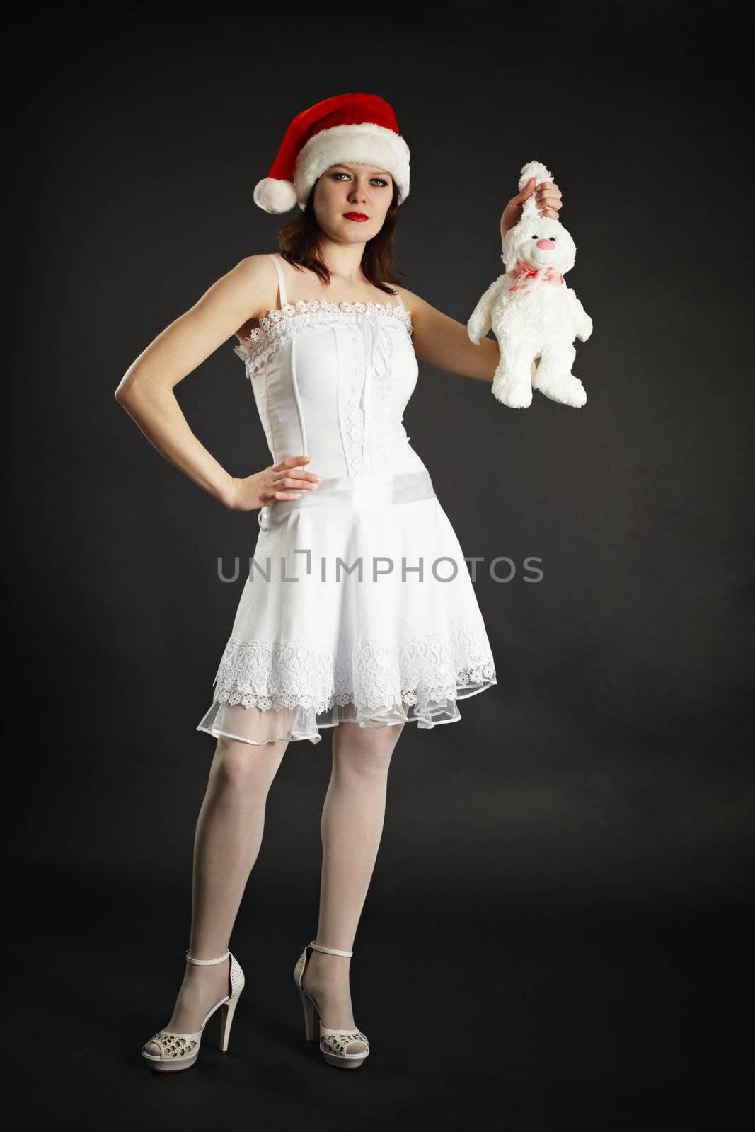 Beautiful girl in white dress holding a white rabbit