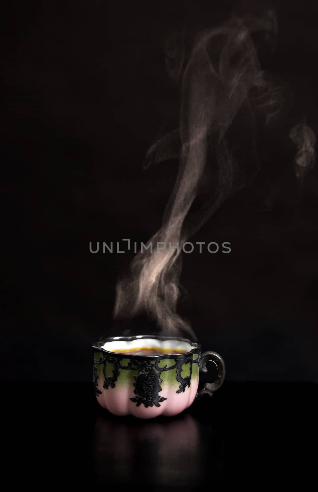 Hot coffee in porcelain antique cup, and smoke above