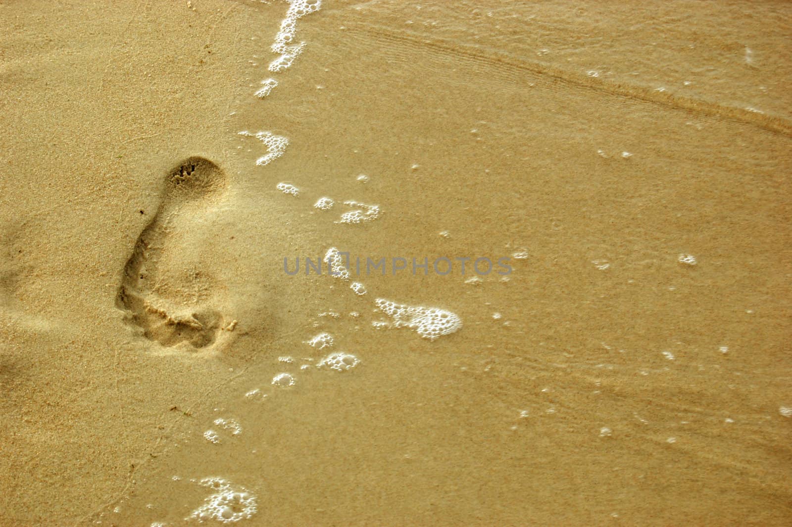 Footprint on sand by johnnychaos