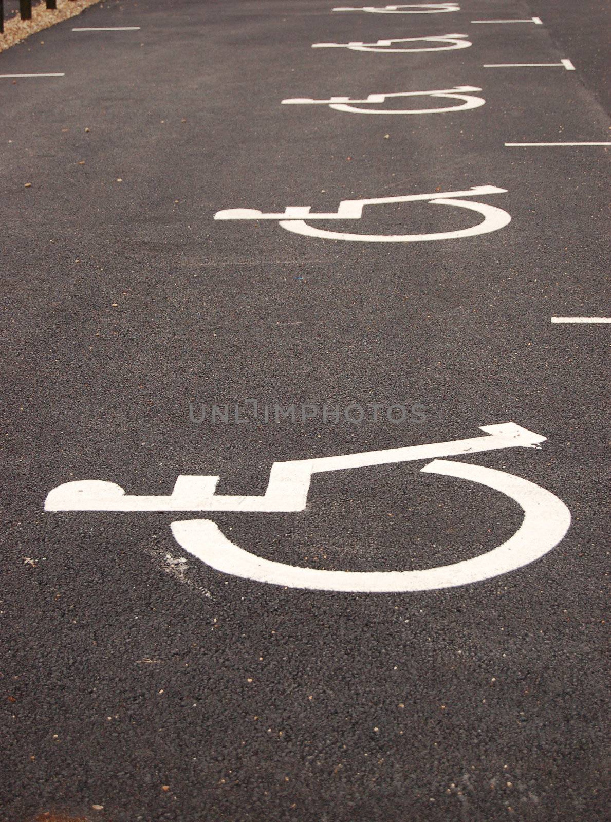 Parking place for handicapped. Sign painted on asphalt