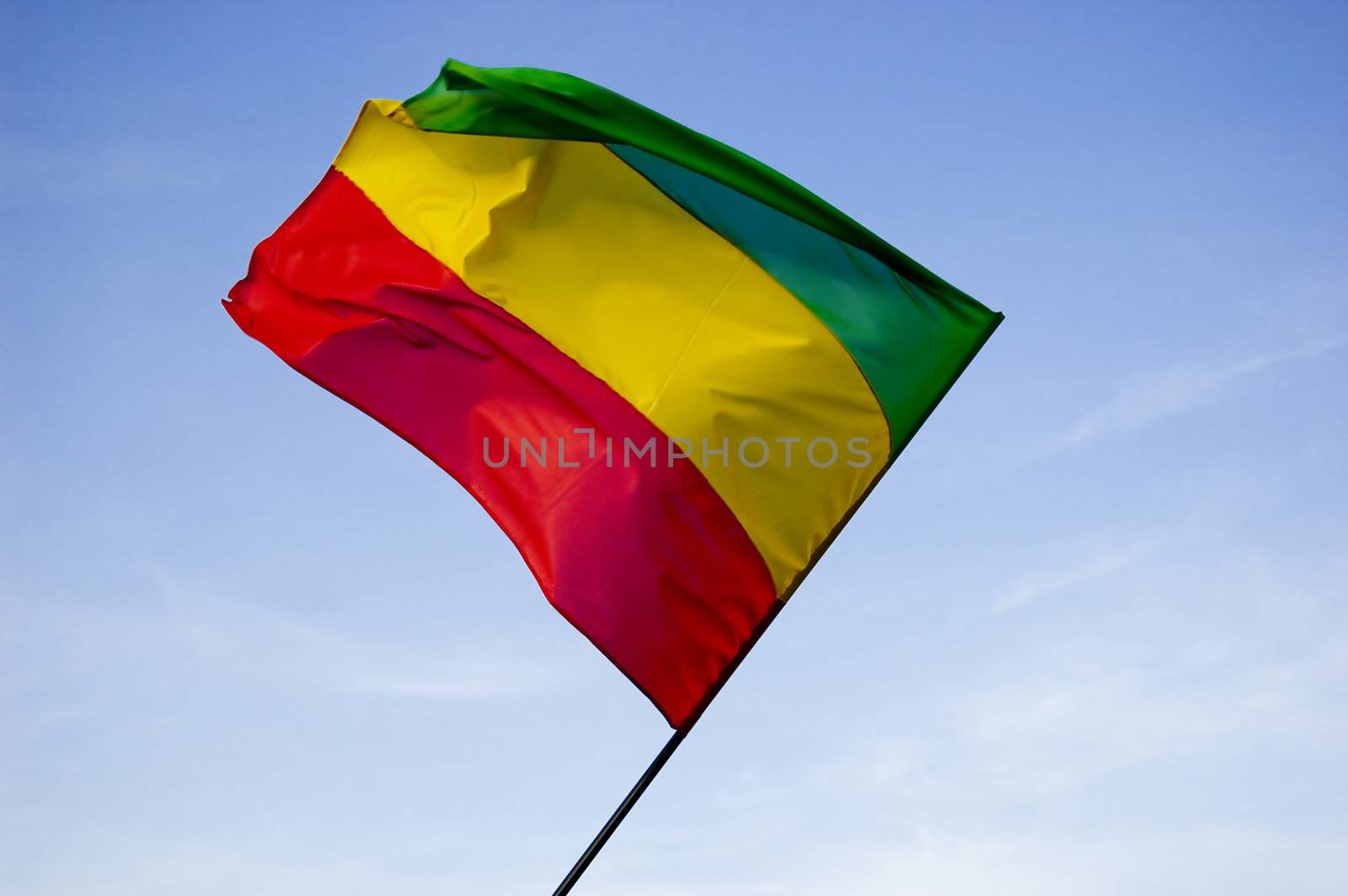 reggae flag over blue sky by johnnychaos