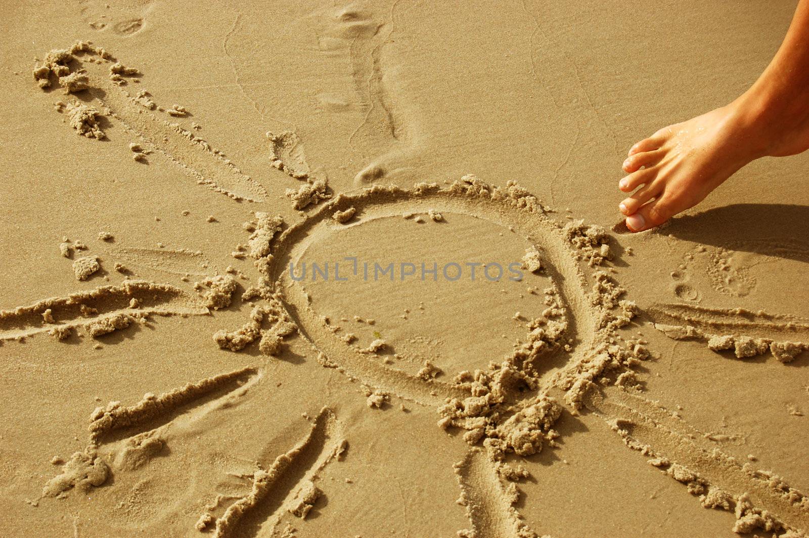 Sun drawn on sany beach. Vacations and summer concept