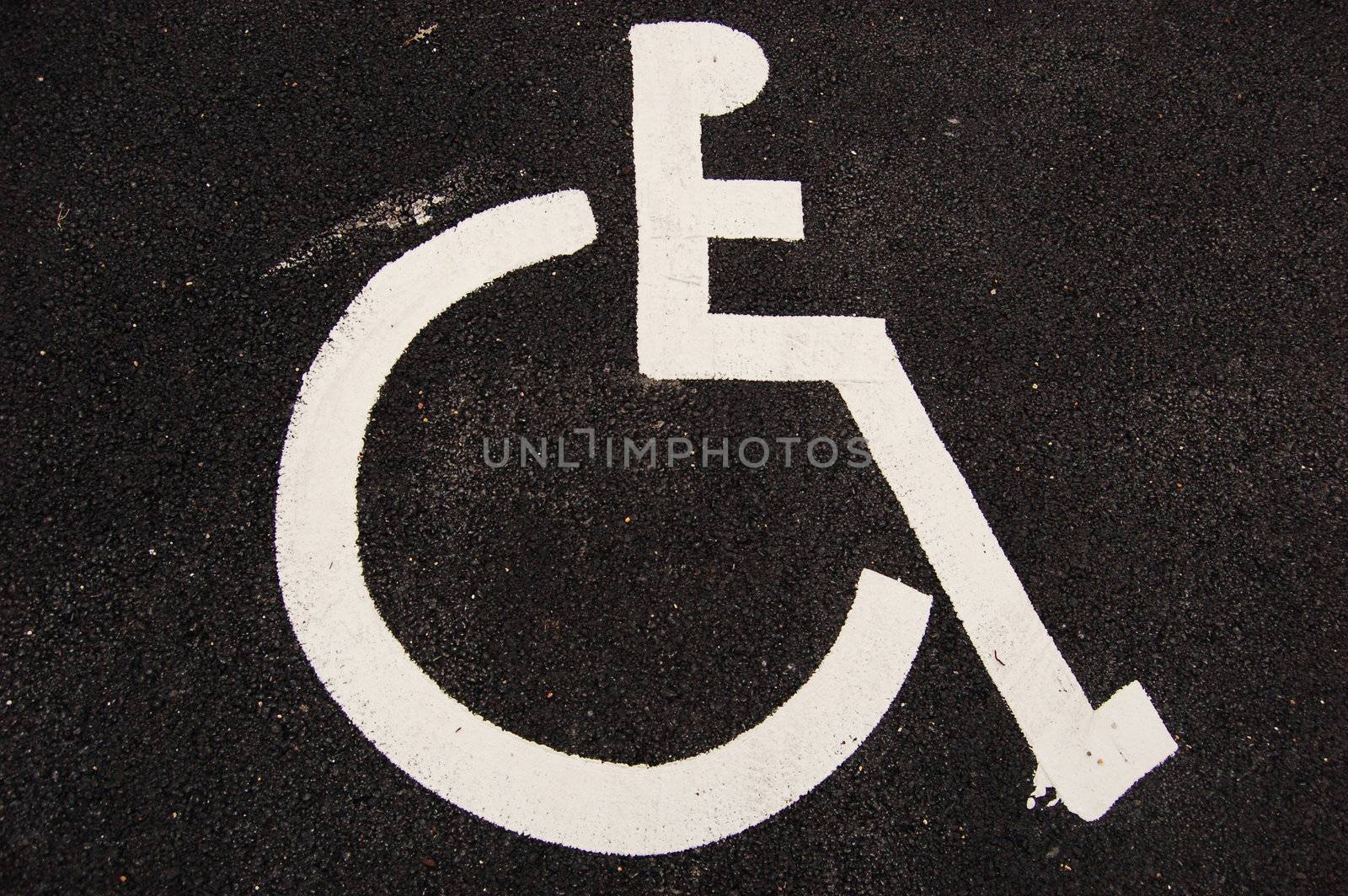 Handicap sign on asphalt by johnnychaos