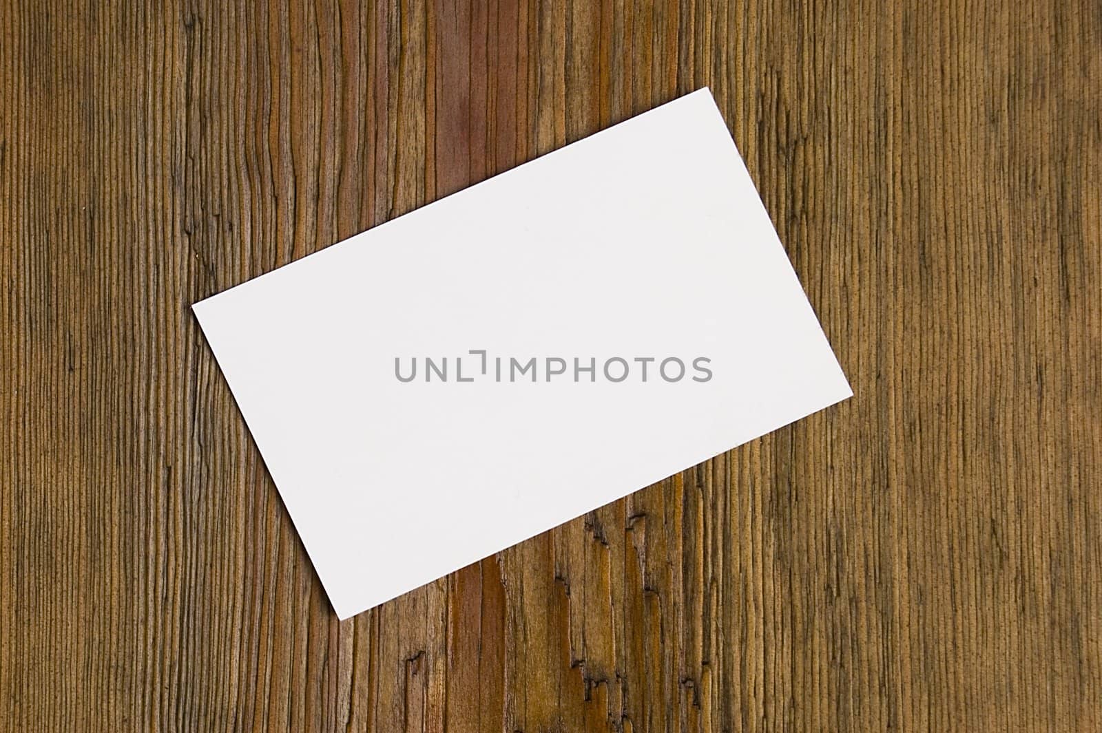 Blank card over wood by johnnychaos