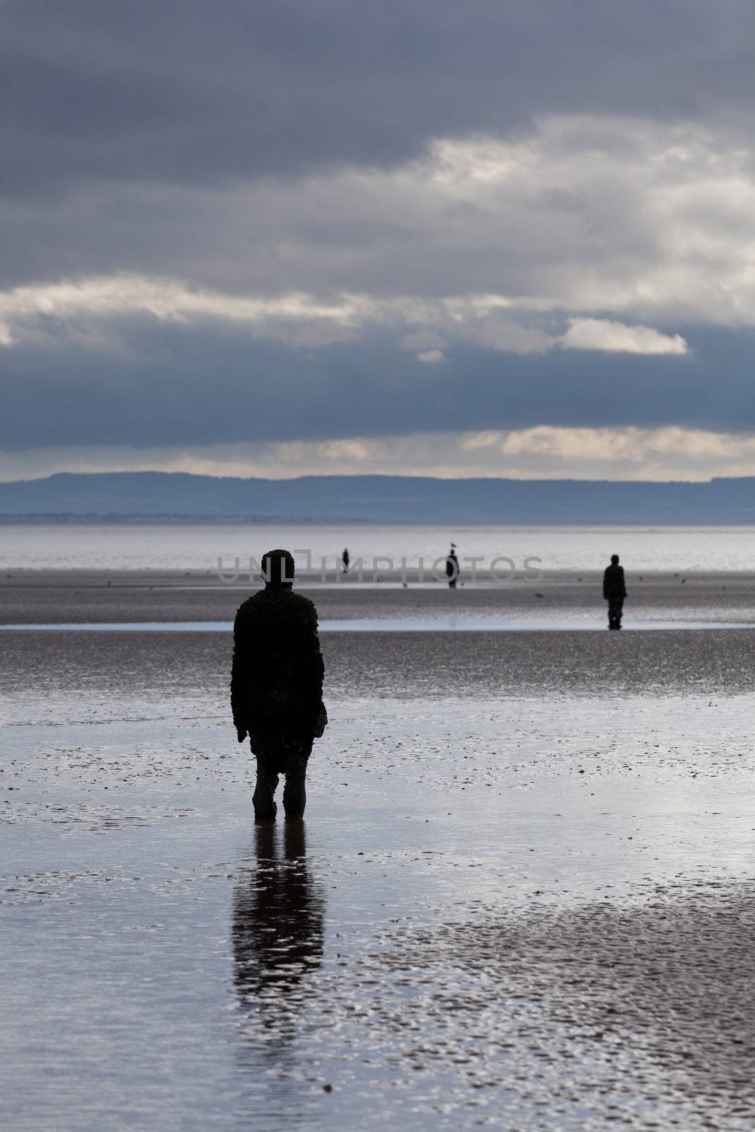 CROSBY BEACH, ENGLAND - SEPTEMBER 24: Statues forming Another Place by Antony Gormley on Crosby Beach on September 24, 2011. The statues are slowly rusting away with the tides and wind.