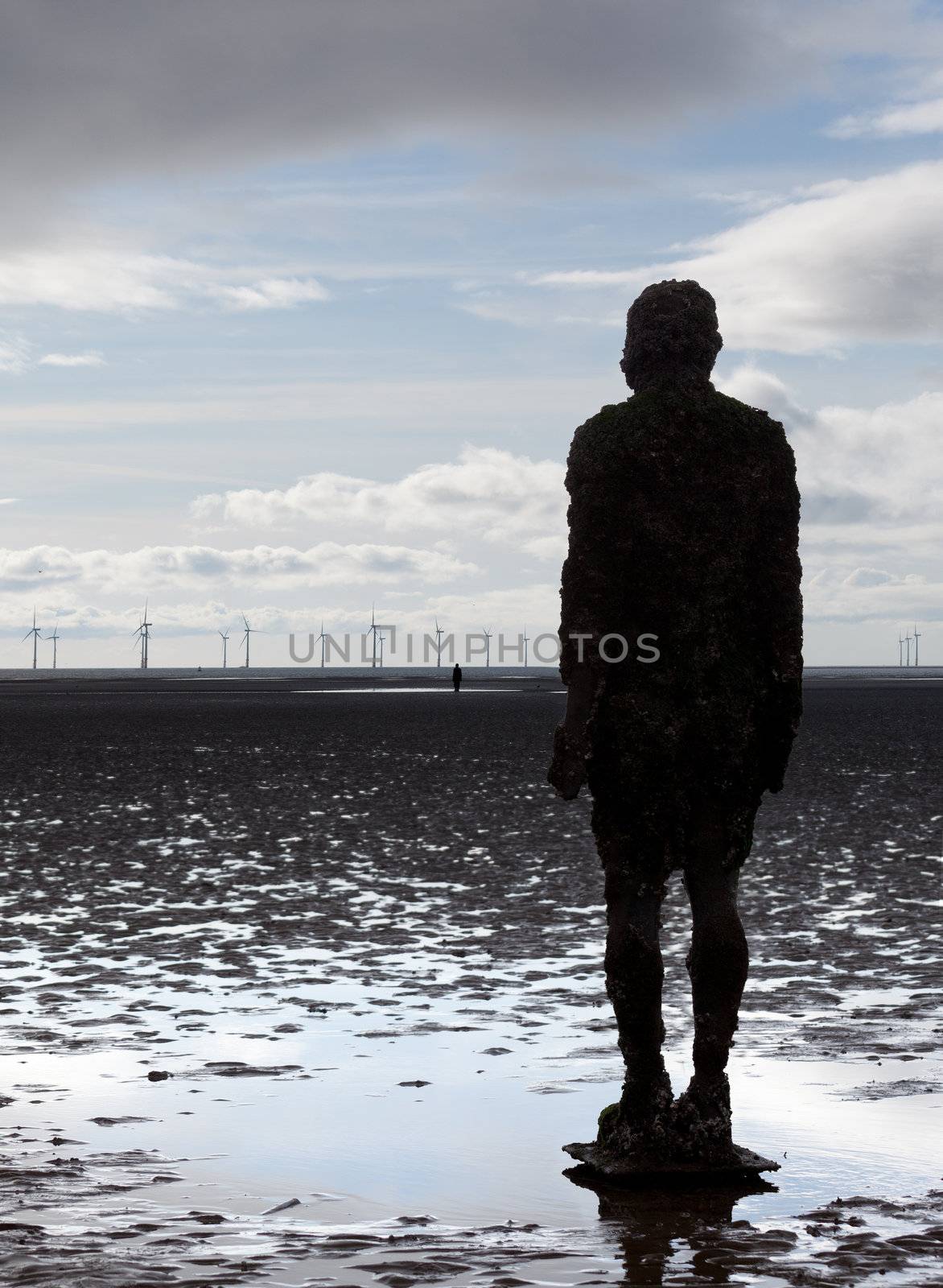 CROSBY BEACH, ENGLAND - SEPTEMBER 24: Statues forming Another Place by Antony Gormley on Crosby Beach on September 24, 2011. The statues are slowly rusting away with the tides and wind.