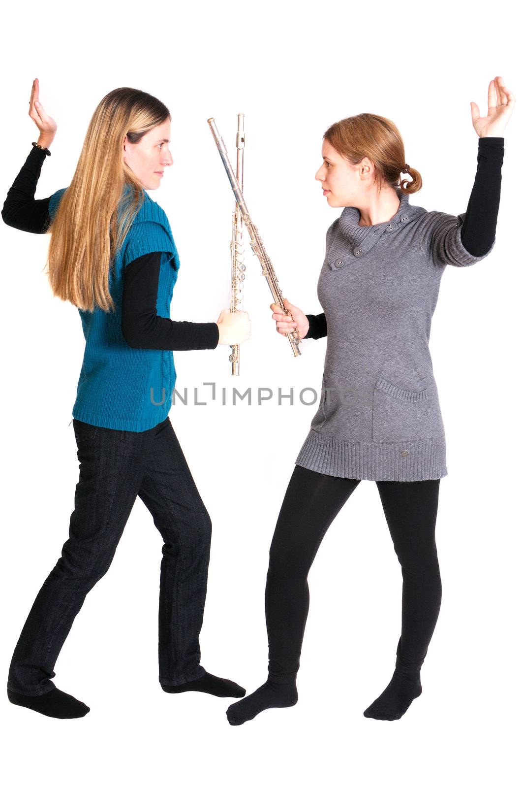 Rivalry between two young women with transverse flute isolated on white background.
