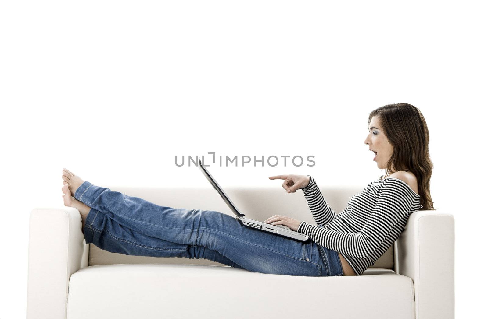 Beautiful woman on a white sofa with a laptop